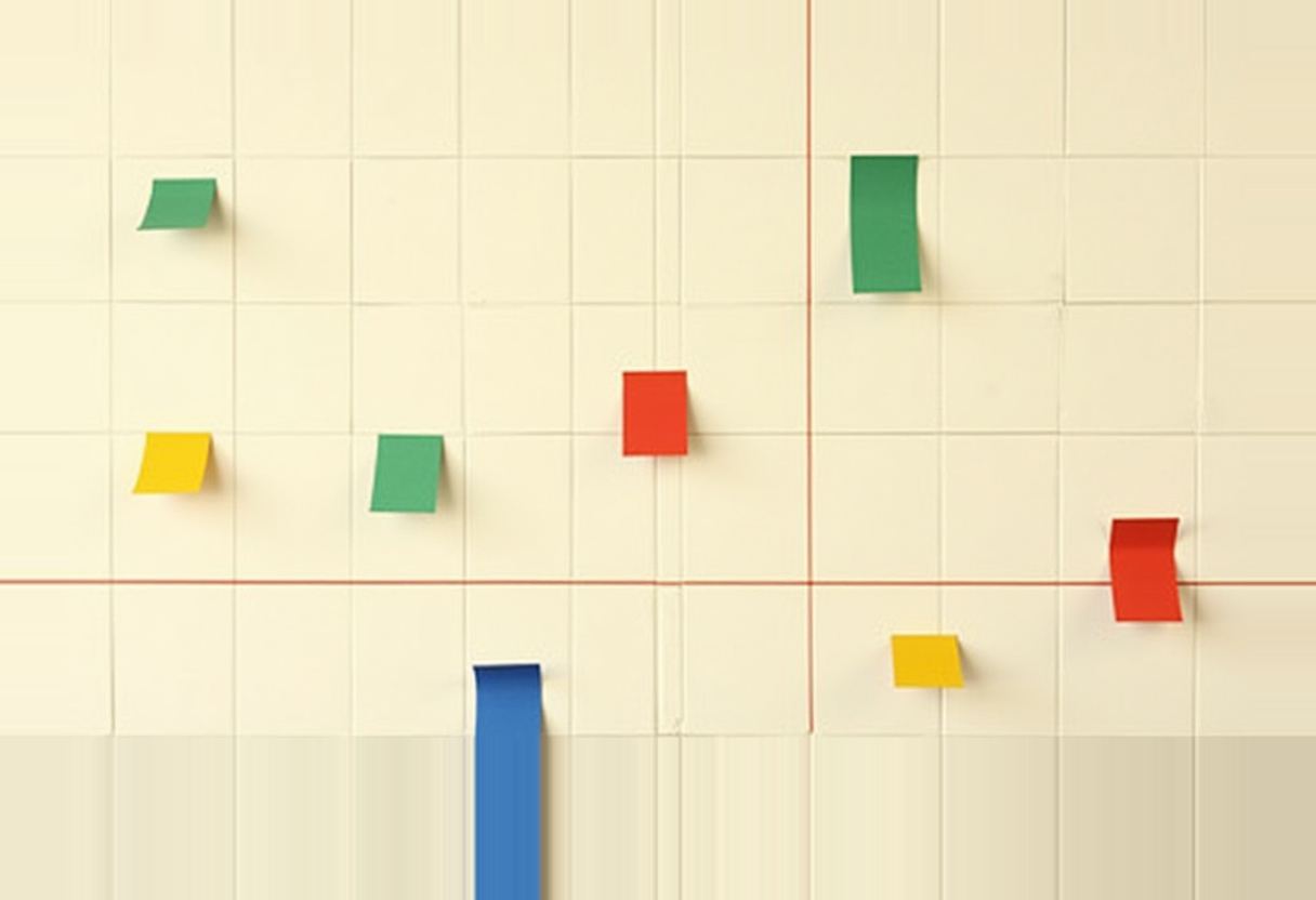 A vast flat grid of small blank paper cells like a trading calendar; exactly six cells scattered across it are filled with solid vermilion, parrot-green, golden-yellow and cobalt blocks, with one long empty stretch across the middle